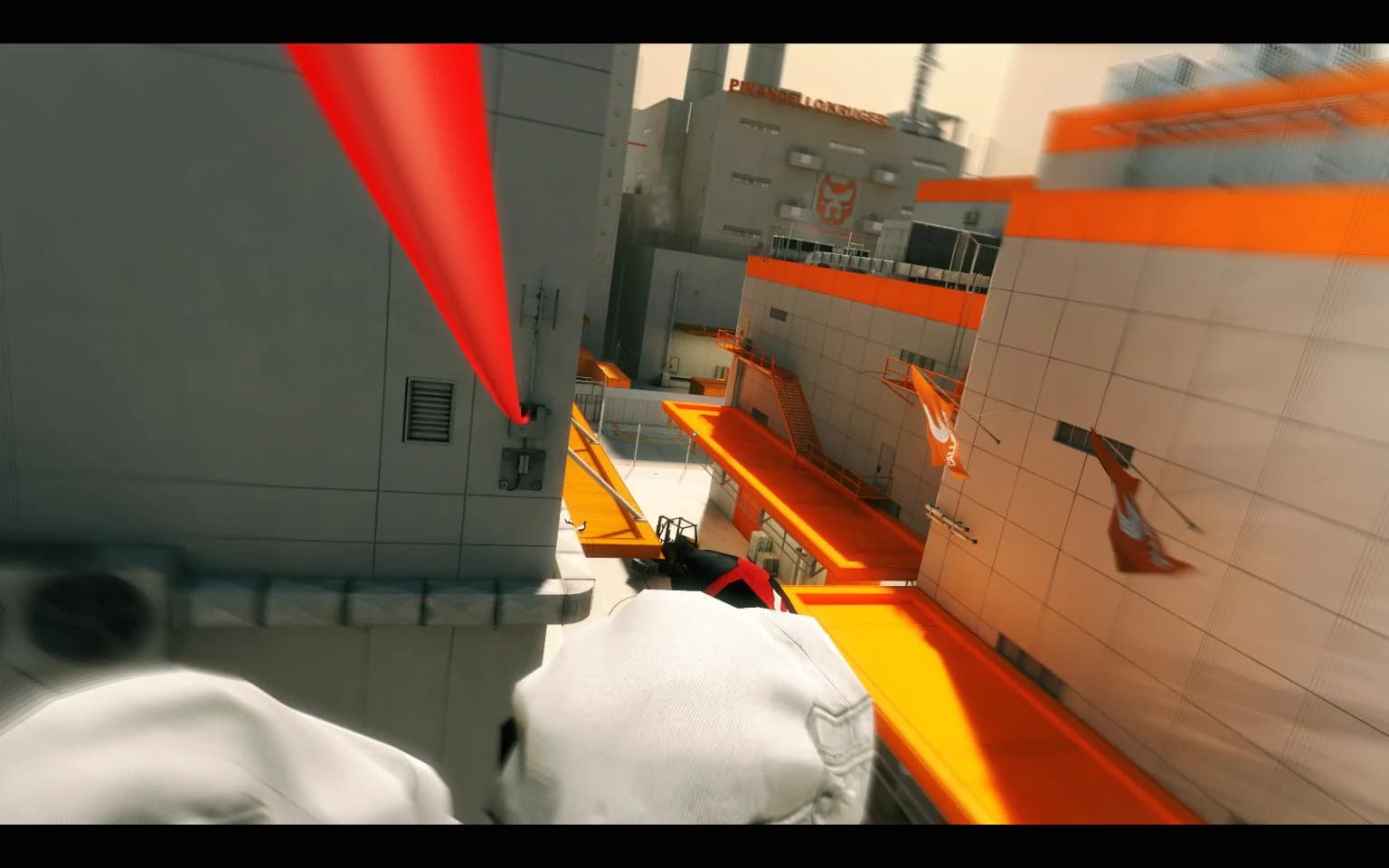 A runner looks down across white rooftops marked by vivid orange paths