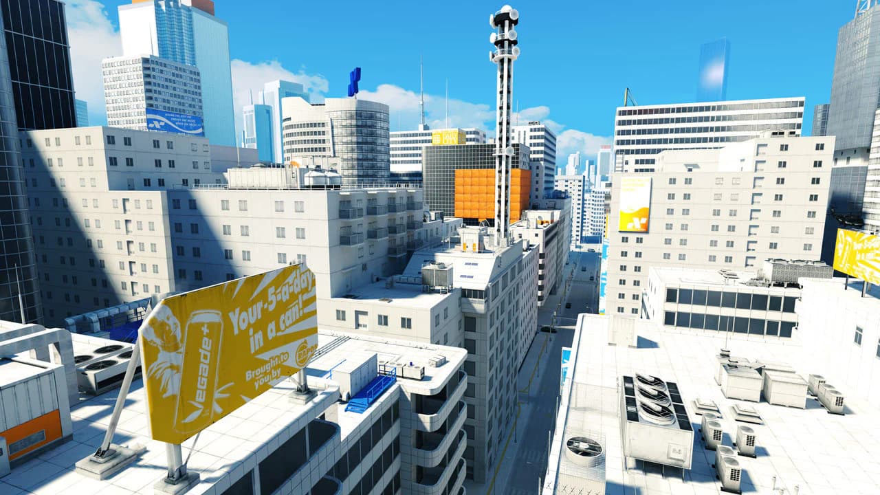 White rooftops and blue glass towers stretch beneath a clear sky